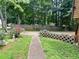 Spacious backyard featuring a long fence, flower bed, and concrete blocks for added privacy at 170 Beatrice St, Dallas, GA 30157