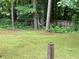 View of the backyard with a hammock strung between trees in a lush green setting, offering a peaceful retreat at 170 Beatrice St, Dallas, GA 30157