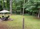 Backyard patio area with a table and chairs, perfect for outdoor dining and entertaining in a lush, natural setting at 170 Beatrice St, Dallas, GA 30157