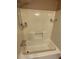 Bathroom with white tub and shower with grab bars and shelving at 170 Beatrice St, Dallas, GA 30157