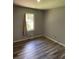 Bedroom with a neutral paint, wood-look floors and natural light at 170 Beatrice St, Dallas, GA 30157