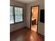 Bedroom featuring a window and doorway leading to an ensuite bathroom at 170 Beatrice St, Dallas, GA 30157