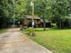 Exterior of a charming two-story home with a well-maintained lawn, mature trees, and inviting covered porch at 170 Beatrice St, Dallas, GA 30157