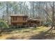 Charming exterior view of a brown home with a covered porch surrounded by lush trees at 170 Beatrice St, Dallas, GA 30157