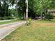 View of the front yard and the driveway with lots of trees, offering ample parking and curb appeal at 170 Beatrice St, Dallas, GA 30157