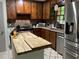 Rustic kitchen featuring wooden cabinets, stainless steel appliances, granite countertops, and a butcher block island at 170 Beatrice St, Dallas, GA 30157