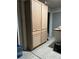 Tall, unfinished wood kitchen cabinets sit on a wooden floor near a doorway, showcasing ample storage at 170 Beatrice St, Dallas, GA 30157