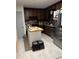 A view of the kitchen with dark cabinets and stainless steel appliances at 170 Beatrice St, Dallas, GA 30157