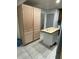 Unfinished wooden kitchen cabinet island with light woodgrain flooring at 170 Beatrice St, Dallas, GA 30157