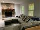 Cozy living room features a stone fireplace, plush sectional sofa, and plenty of natural light at 170 Beatrice St, Dallas, GA 30157