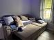 A large sectional sofa sits in a well-lit living room with comfortable pillows and a nearby window at 170 Beatrice St, Dallas, GA 30157