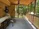 Relaxing screened porch with ceiling fan and view of the lush, wooded backyard at 170 Beatrice St, Dallas, GA 30157