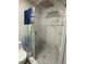 Beautiful shower featuring marble-look tiling and a built-in corner seat at 170 Beatrice St, Dallas, GA 30157