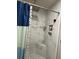 Beautiful shower featuring marble-look tiling and a built-in corner seat at 170 Beatrice St, Dallas, GA 30157