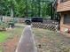 Side yard with a walkway and landscaping, providing a charming transition from the front to the back of the house at 170 Beatrice St, Dallas, GA 30157