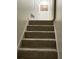 Carpeted staircase with neutral walls leading to the upper level of the home at 170 Beatrice St, Dallas, GA 30157
