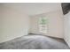 Neutral bedroom with gray carpet and a window providing natural light and neighborhood views at 2901 Lenox Rd # 702, Atlanta, GA 30324
