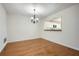 Cozy dining room featuring hardwood floors, a chandelier, and a view to the kitchen at 2901 Lenox Rd # 702, Atlanta, GA 30324