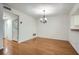 The Dining Room features hardwood floors, a chandelier, and seamless access to the kitchen at 2901 Lenox Rd # 702, Atlanta, GA 30324