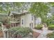 Charming townhome with a spacious covered porch, lush landscaping, and inviting entry way at 2901 Lenox Rd # 702, Atlanta, GA 30324