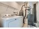 Functional laundry room with washer, dryer, shelving, and water heater at 2901 Lenox Rd # 702, Atlanta, GA 30324