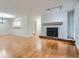 Open living area with hardwood floors, a fireplace, and a view into the kitchen at 2901 Lenox Rd # 702, Atlanta, GA 30324