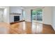 Bright living room featuring a fireplace, hardwood floors, and sliding glass door to outdoor space at 2901 Lenox Rd # 702, Atlanta, GA 30324