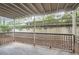 Private covered patio with a view of the surrounding greenery and fencing at 2901 Lenox Rd # 702, Atlanta, GA 30324