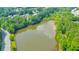 This aerial view showcases the serene pond surrounded by lush greenery in the community at 3816 Harris Nw Blvd, Kennesaw, GA 30144