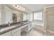 Bright bathroom with double sinks, granite countertops, a soaking tub, and a glass-enclosed shower at 3816 Harris Nw Blvd, Kennesaw, GA 30144