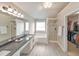 Bright bathroom with double sinks, granite counters, a walk-in closet, and a separate shower at 3816 Harris Nw Blvd, Kennesaw, GA 30144