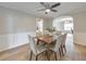 Traditional dining room boasts wainscoting, a ceiling fan, and a view into the kitchen at 3816 Harris Nw Blvd, Kennesaw, GA 30144