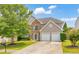 Charming two-story home featuring a stone facade, well-manicured lawn, and a two-car garage at 3816 Harris Nw Blvd, Kennesaw, GA 30144
