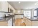 Bright kitchen features white cabinets, granite countertops, stainless appliances, and backyard access at 3816 Harris Nw Blvd, Kennesaw, GA 30144
