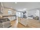 Open-concept kitchen offers white cabinets, granite countertops, a center island, and backyard access at 3816 Harris Nw Blvd, Kennesaw, GA 30144