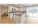 Modern kitchen features white cabinetry, an island, stainless appliances, and sliding door access at 3816 Harris Nw Blvd, Kennesaw, GA 30144