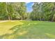 A grassy lawn leads to a covered pavilion in the Legacy Park Community surrounded by lots of trees at 3816 Harris Nw Blvd, Kennesaw, GA 30144