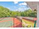 View from a balcony of fenced tennis courts and lush foliage, showcasing outdoor recreational options at 3816 Harris Nw Blvd, Kennesaw, GA 30144