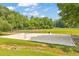 Volleyball court on a sunny day in Legacy Park surrounded by green grass and mature trees at 3816 Harris Nw Blvd, Kennesaw, GA 30144