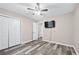 Bedroom features closet, TV, ceiling fan, and natural light with a neutral color scheme at 4274 Timber Trace Road, Loganville, GA 30052