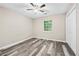 Bright bedroom featuring wood-look floors, ceiling fan, and closet at 4274 Timber Trace Road, Loganville, GA 30052