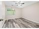 Comfortable bedroom featuring wood-look floors, ceiling fan, and natural light at 4274 Timber Trace Road, Loganville, GA 30052