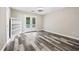 Bright bedroom with a built in bookcase, patio access and grey hardwood flooring at 4274 Timber Trace Road, Loganville, GA 30052