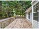 Wooden deck overlooks wooded backyard, leading to door to go inside at 4274 Timber Trace Road, Loganville, GA 30052