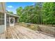 Large wooden deck leads to screened in porch, overlooking back yard at 4274 Timber Trace Road, Loganville, GA 30052