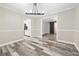 Open dining room with modern light fixture and doorway to kitchen at 4274 Timber Trace Road, Loganville, GA 30052