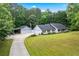 Well-maintained home with attached garages and meticulously manicured front lawn at 4274 Timber Trace Road, Loganville, GA 30052