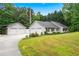 Ranch-style home with detached garage, ample parking, and well-maintained landscaping at 4274 Timber Trace Road, Loganville, GA 30052