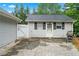Detached garage with an adjacent fenced area and paved driveway, perfect for vehicle storage at 4274 Timber Trace Road, Loganville, GA 30052