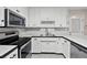 Modern kitchen featuring white cabinetry, stainless steel appliances, and ample counter space at 4274 Timber Trace Road, Loganville, GA 30052